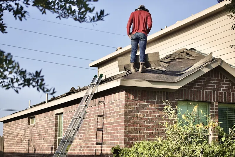 Professional roofer working on a residential roof in Lexington Town Center